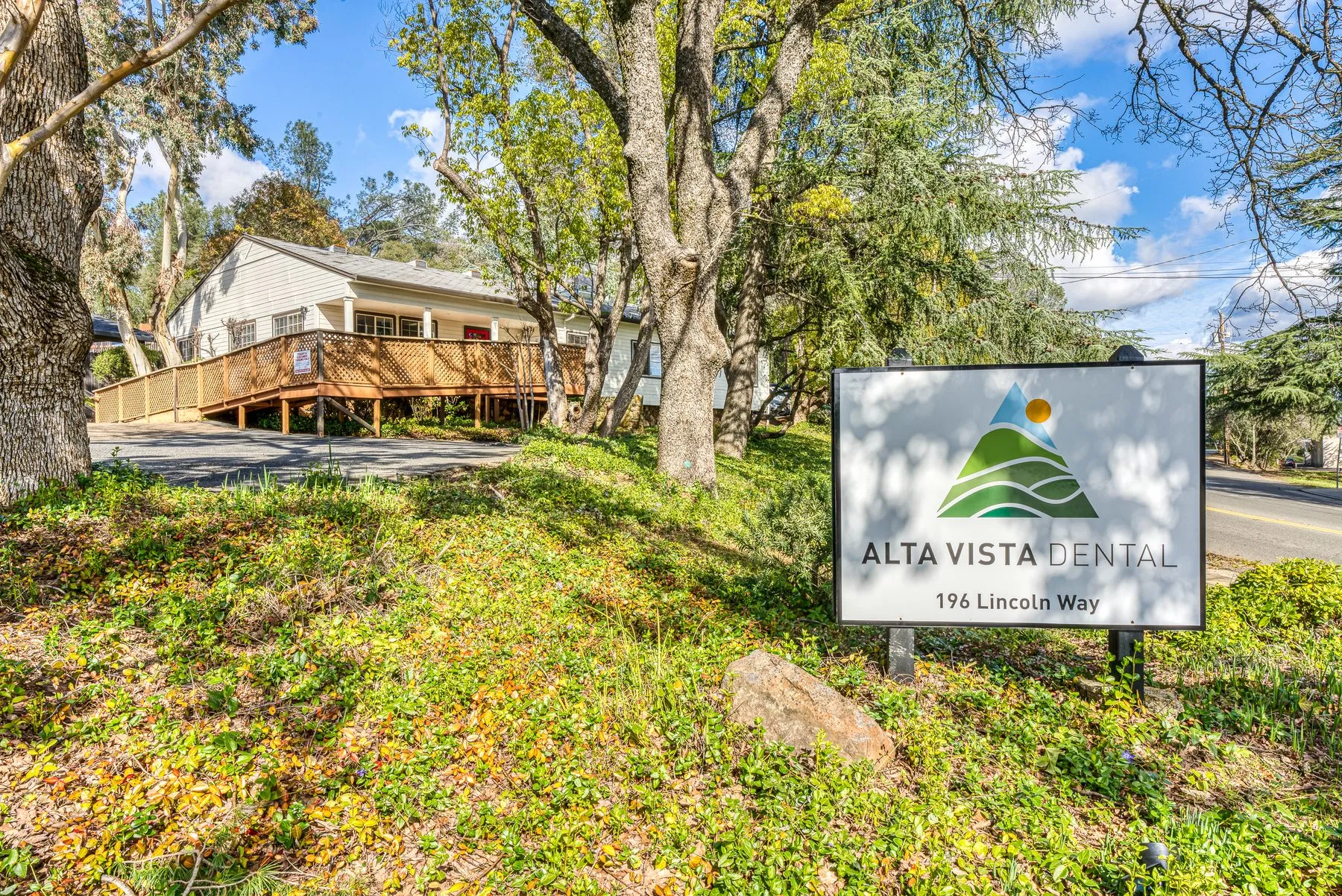The Alta Vista Dental sign for 196 Lincoln Way, with the white office building behind it