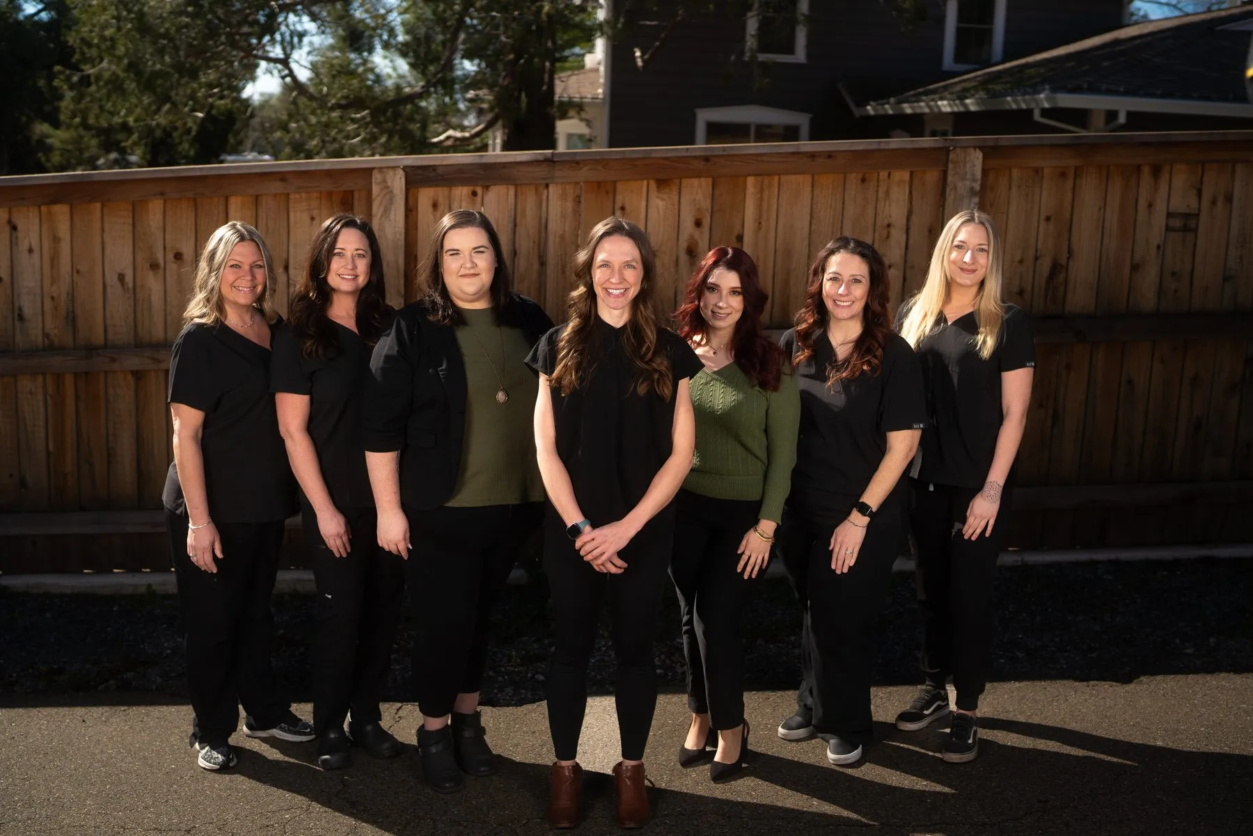 The seven-person Alta Vista Dental Care team standing together outside the office